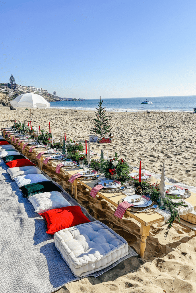 Boho Beach Christmas Party with Long Wooden Tables and Cushions — Christmas Party Decor