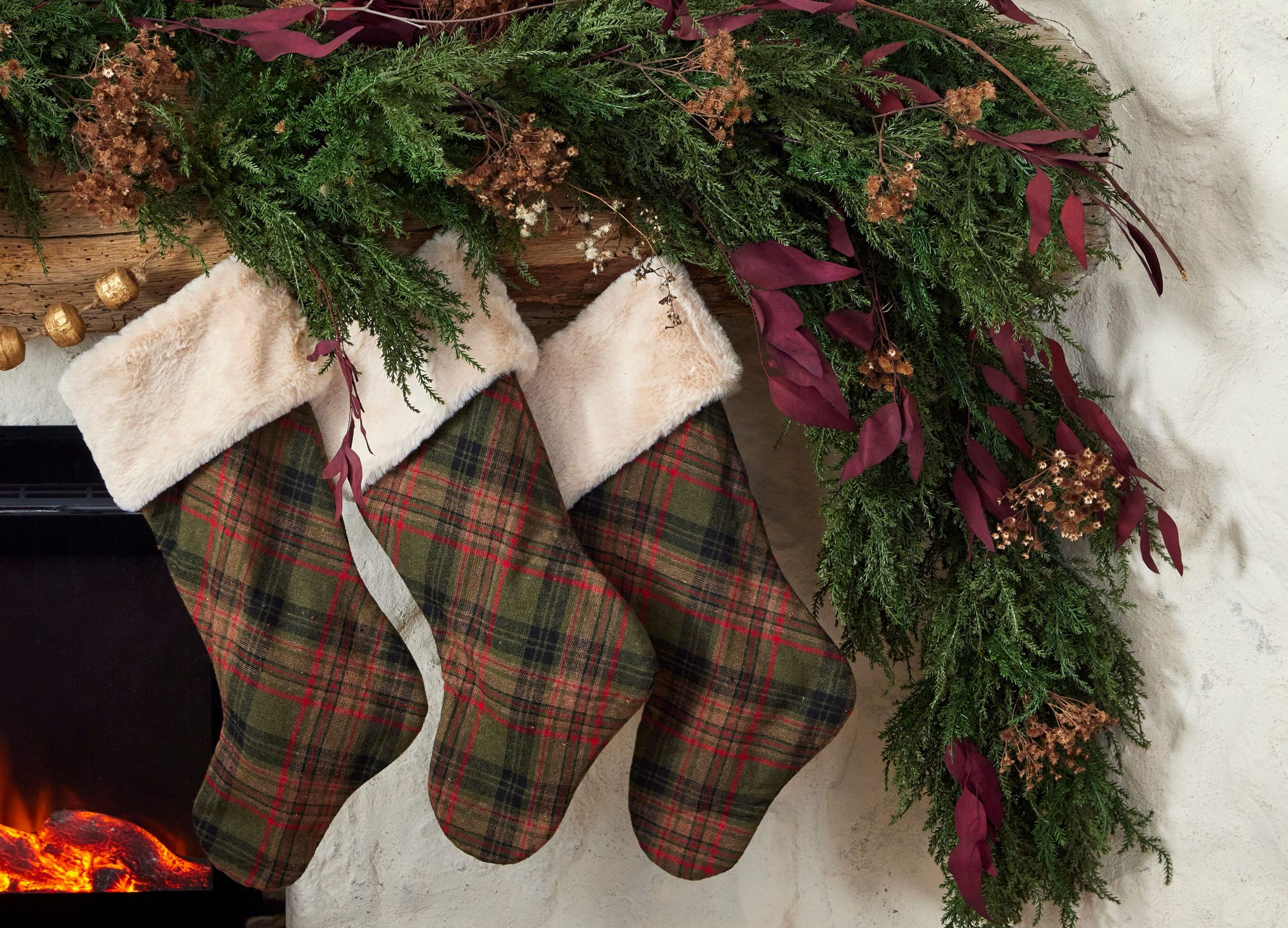 Plaid Christmas Stockings with Faux Fur Trim on a Greenery Garland — Burgundy Christmas Decor