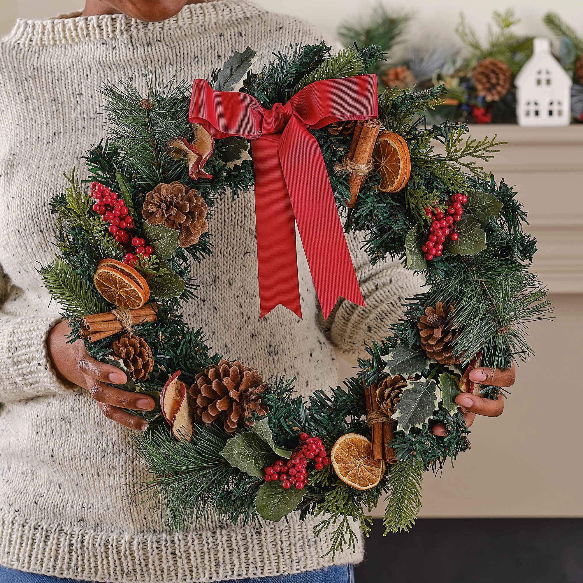 Natural Elements Wreath Held by Hand: A Cozy Fireside Display — DIY Christmas Wreath