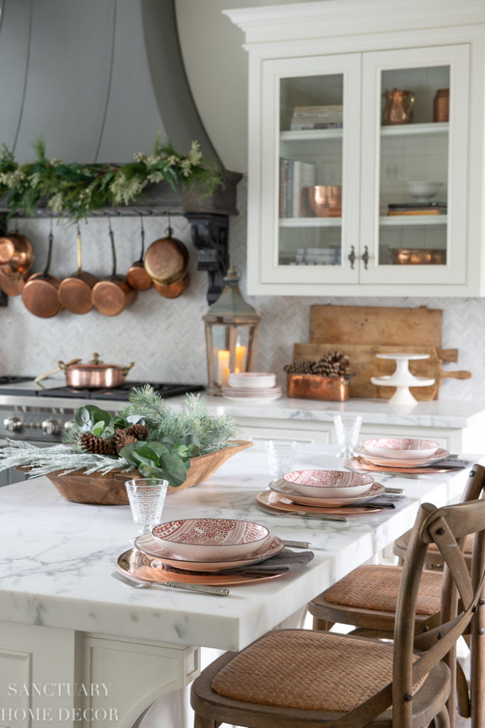 Farmhouse Kitchen Island Table Setting with Festive Plates and Natural Centerpiece — Christmas Kitchen Decor