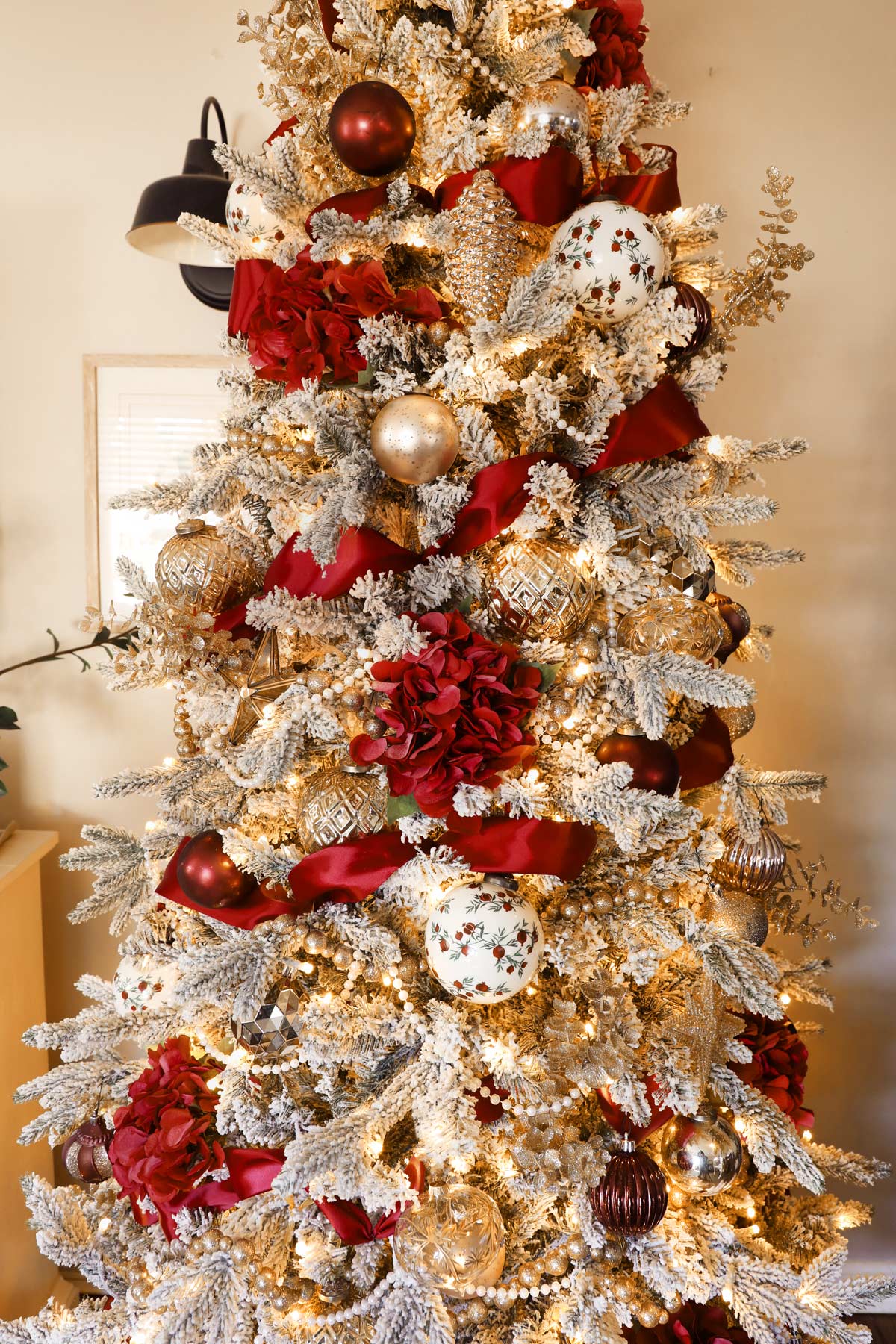Elegant Florals: Red Flower Accents on Flocked Christmas Tree Elegant Florals: Red Flower Accents on Flocked Christmas Tree — Flocked Christmas Tree Decor