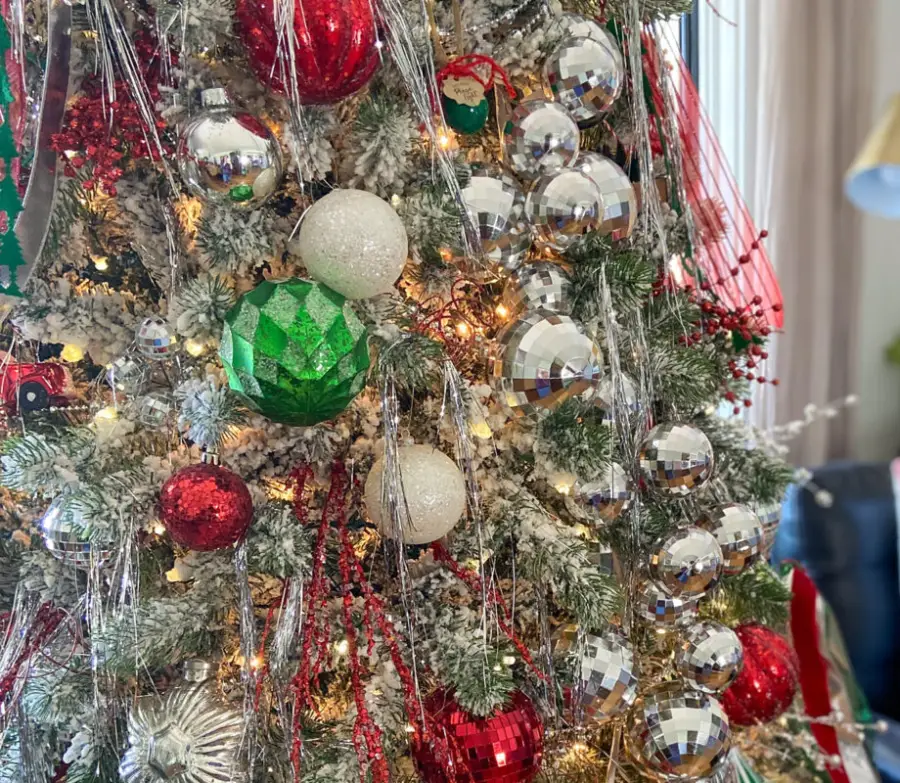 Festive Christmas Tree Detail with Disco Ball Ornaments Festive Christmas Tree Detail with Disco Ball Ornaments — christmas decor trends 2026
