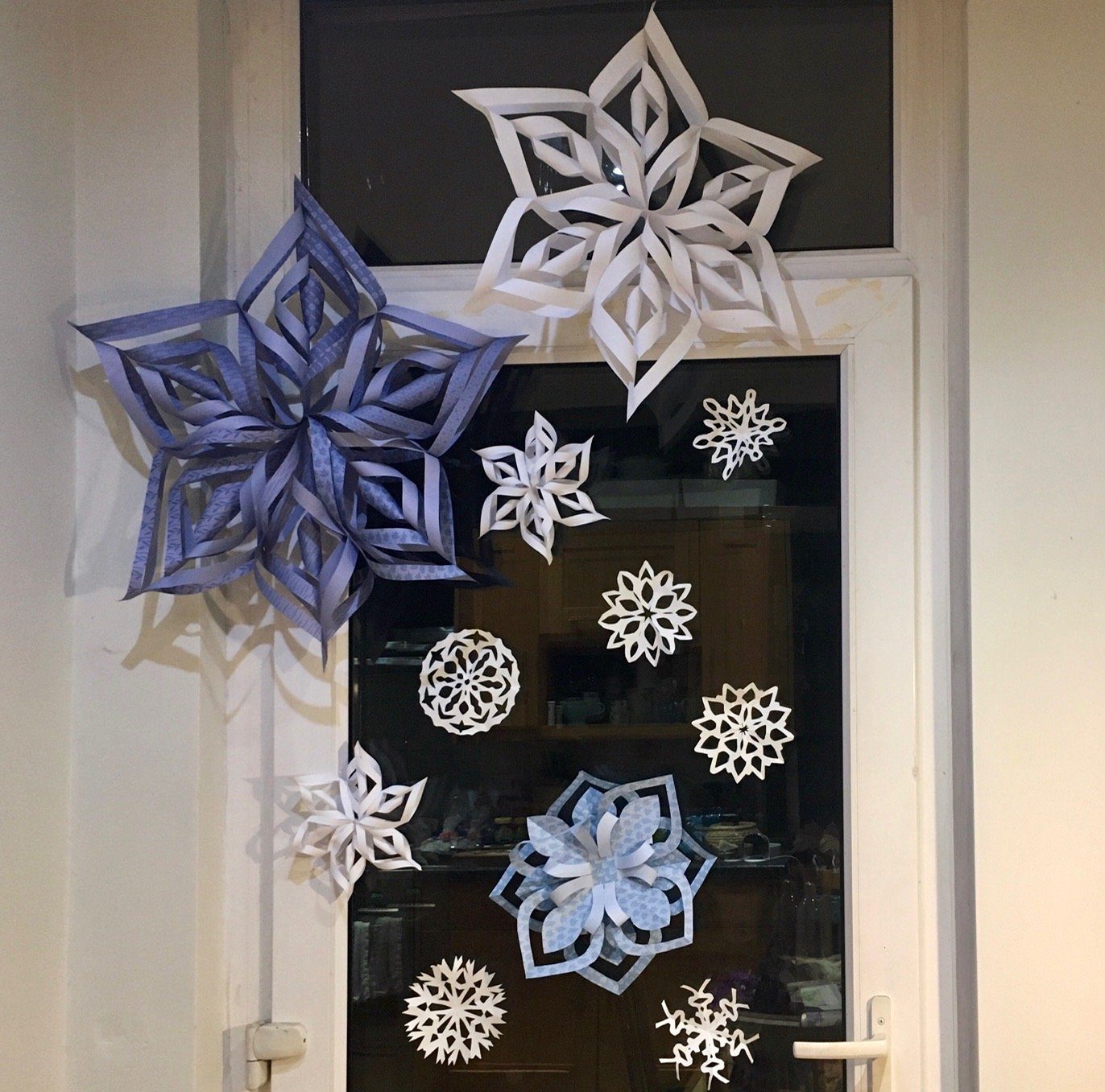 Window and Door Decorated with Varied Paper Snowflakes