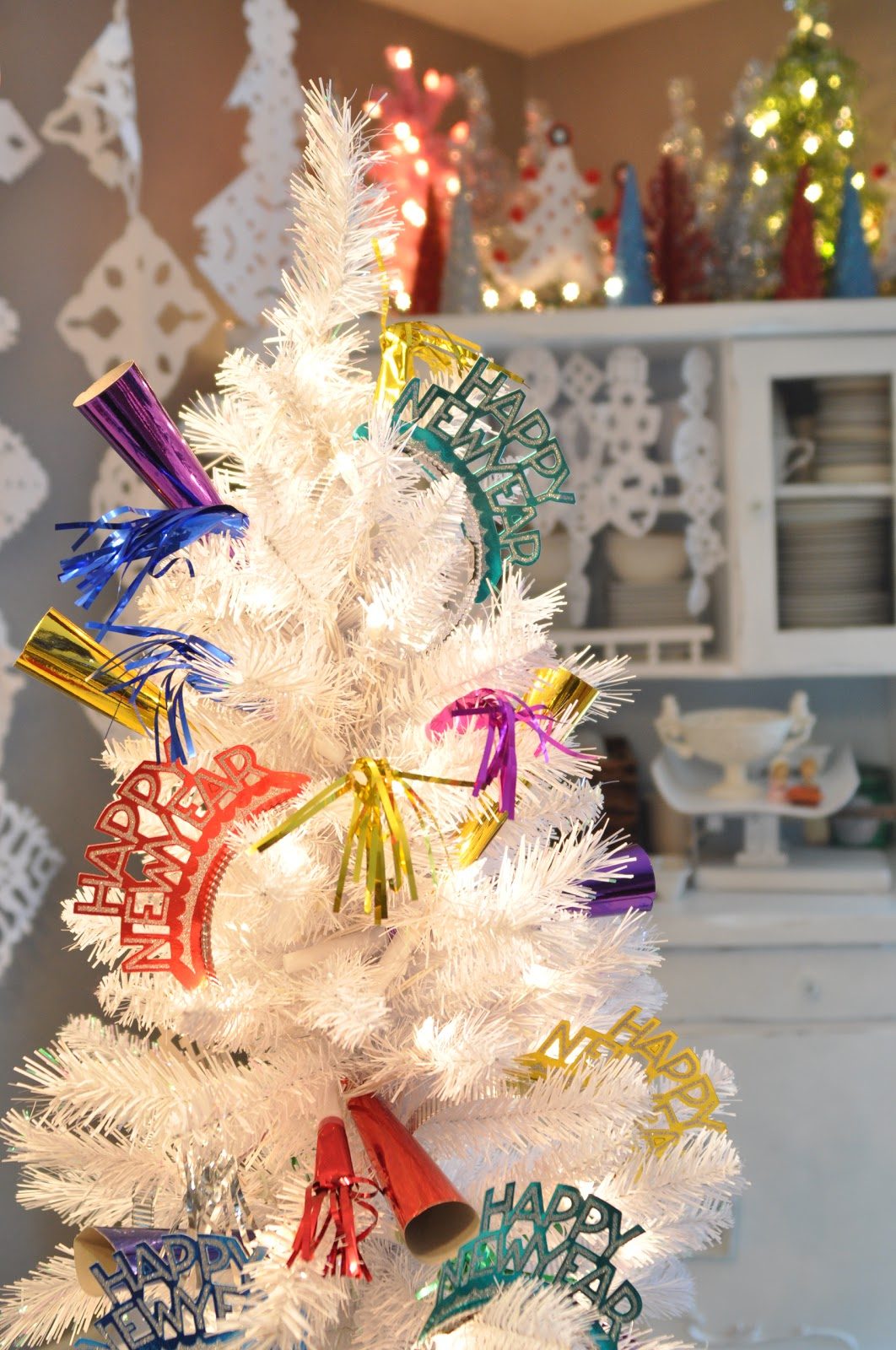 White Artificial Tree Decorated with 'Happy New Year' Cutouts — New Years Eve Party Decor