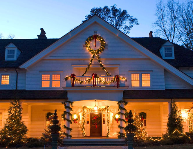Traditional White House with a Warmly Lit Porch — Christmas House Exterior Decor