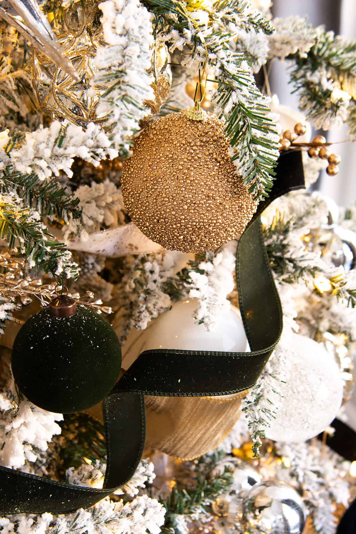 Close-Up of Flocked Christmas Tree with Gold and Glitter Accents — White Christmas Tree Decor