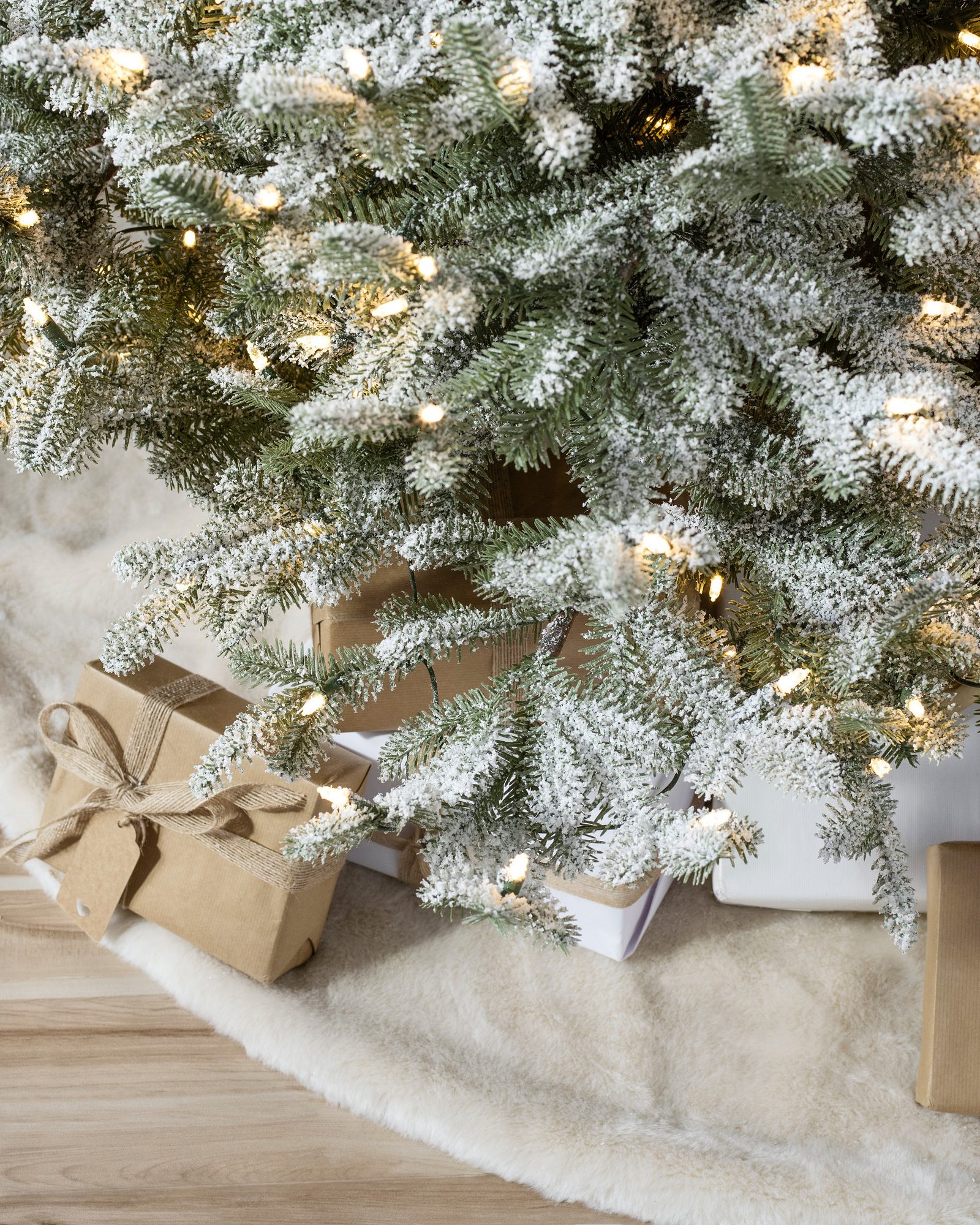 Natural Gift Wrap: Kraft Paper and Jute Bows on Flocked Tree Base Natural Gift Wrap: Kraft Paper and Jute Bows on Flocked Tree Base — Flocked Christmas Tree Decor