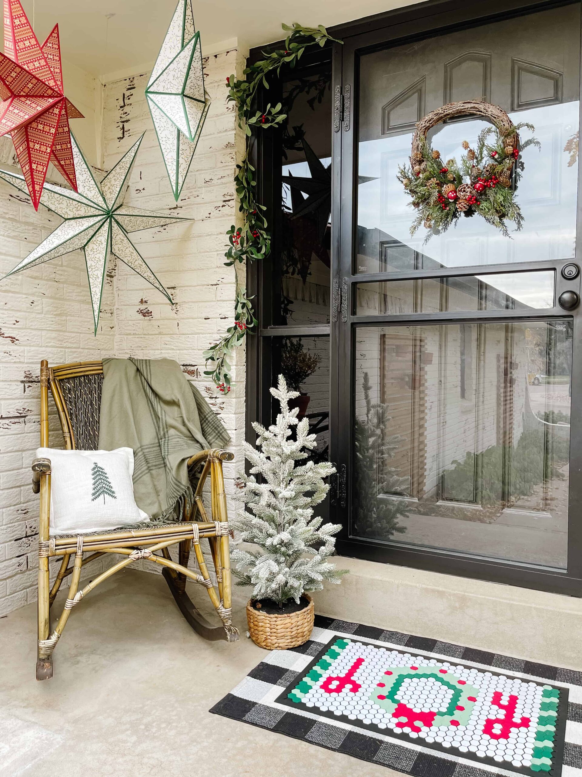 Cozy Vignette with Wicker Chair, Star Lanterns, and Flocked Tree — Farmhouse Christmas Porch