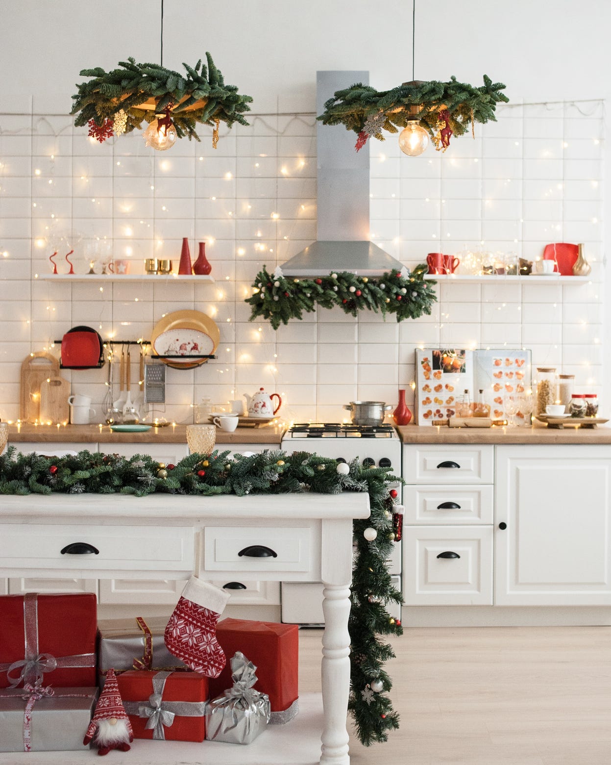 Festive Christmas Decor and Gifts on a White Kitchen Island Festive Christmas Decor and Gifts on a White Kitchen Island — Christmas Apartment Decor