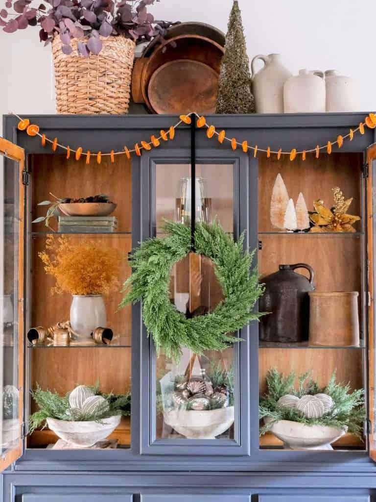 Farmhouse Cabinet with Green Wreath and Trees Farmhouse Cabinet with Green Wreath and Trees — Winter Decor After Christmas