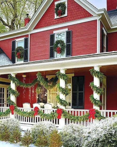 Red House Porch with Abundant Christmas Garland — Christmas House Exterior Decor