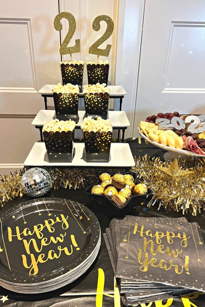 Festive Snack Bar with Gold Confetti Popcorn Boxes and Charcuterie Board — New Years Eve Party Decor