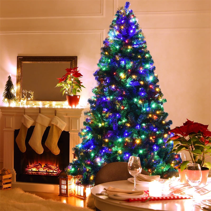 Brightly Lit Flocked Tree Next to a Fireplace with Poinsettias Brightly Lit Flocked Tree Next to a Fireplace with Poinsettias — Christmas Tree with Colored Lights