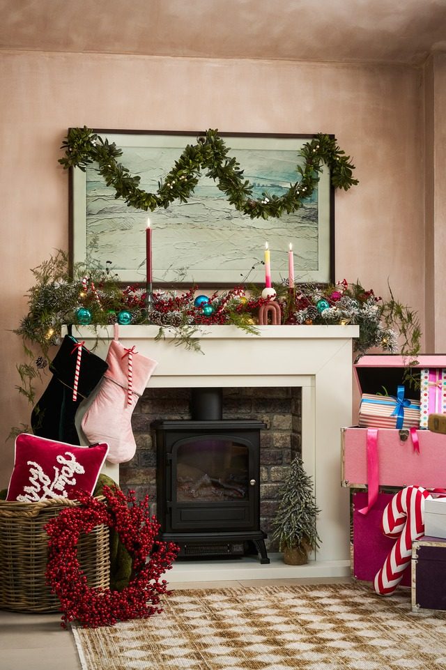 Contemporary Fireplace with Pink and Red Stacked Boxes and Garland Contemporary Fireplace with Pink and Red Stacked Boxes and Garland — Christmas Fireplace Decor