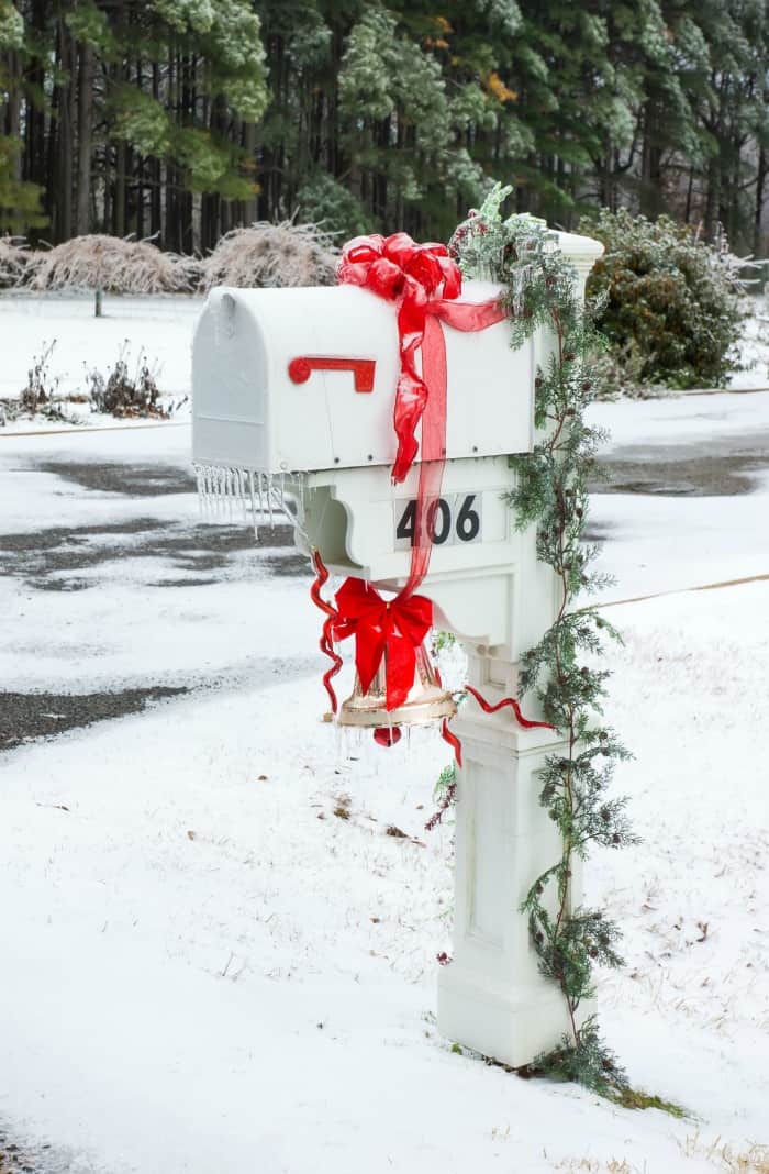 Traditional White Mailbox with Red Bows, Pine Garland, and Hanging Bell — Christmas Mailbox Decor