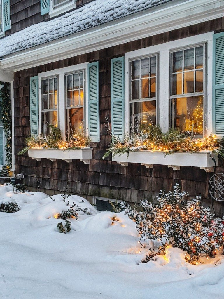 Coastal House with Snow-Covered Window Boxes and Lights — Christmas House Exterior Decor