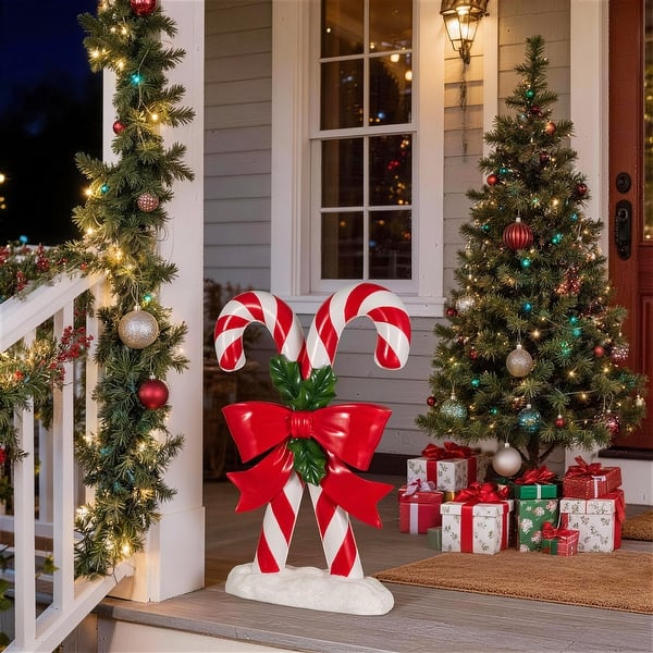 Festive Porch Display Featuring Oversized Candy Canes — Christmas Yard Decor