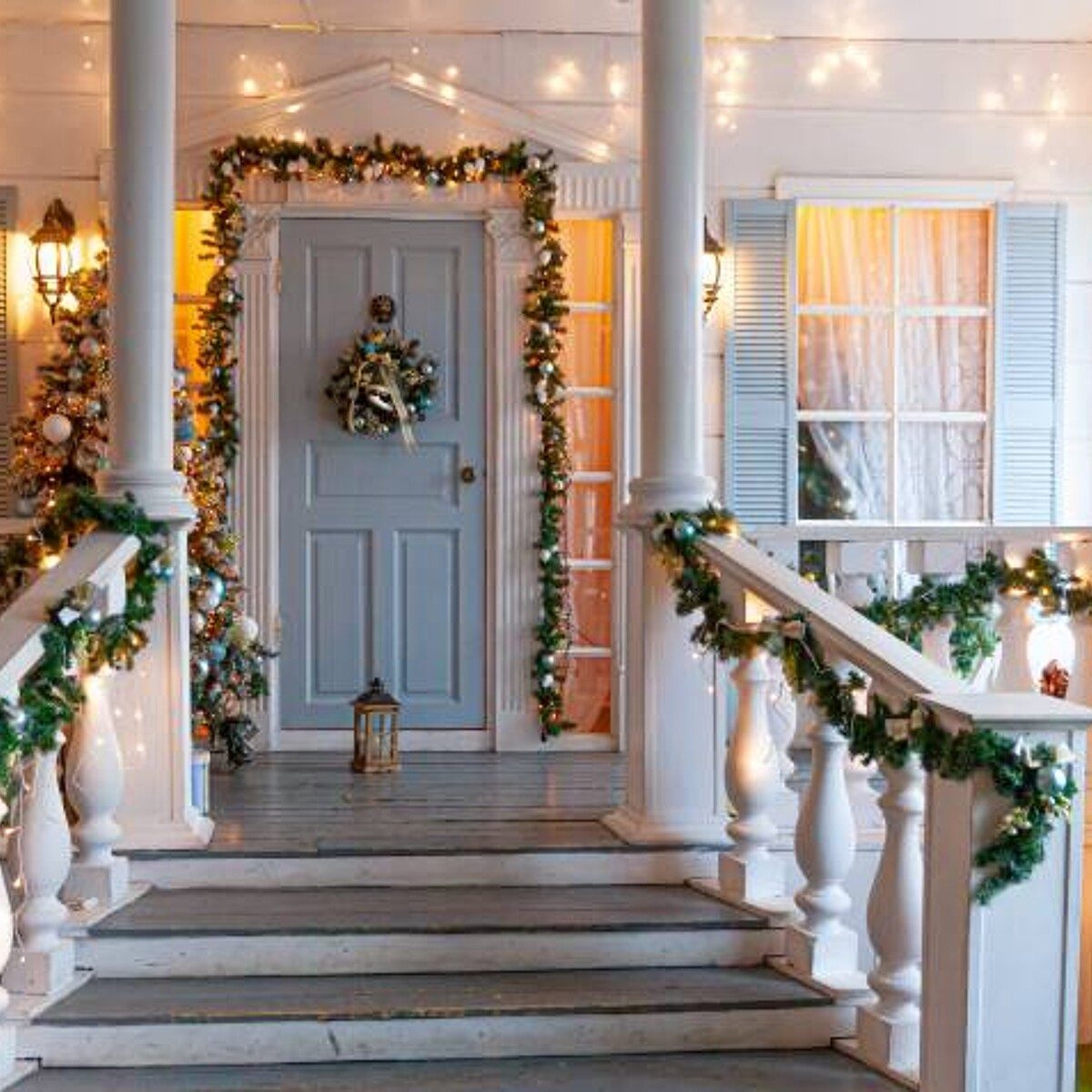Welcoming Porch with Abundant Garland and Staircase Lights — Outdoor Christmas Lights