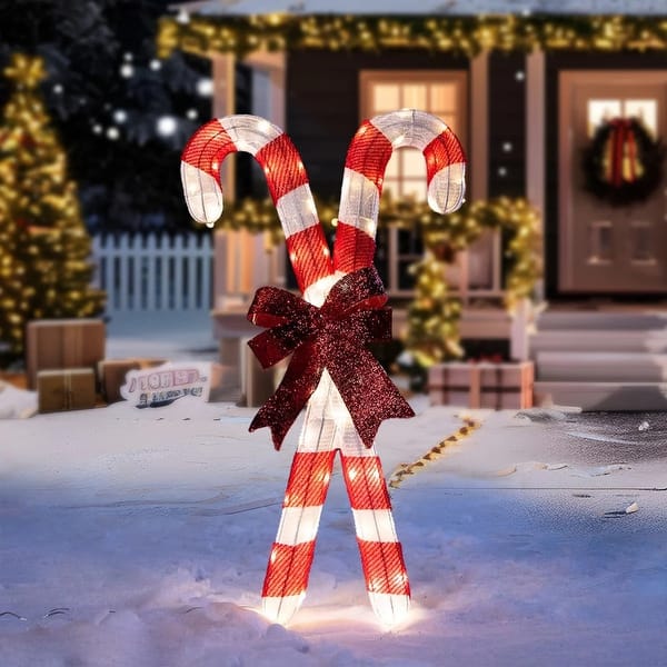 Illuminated Candy Canes in a Snowy Yard Display — Candy Cane Christmas Decor
