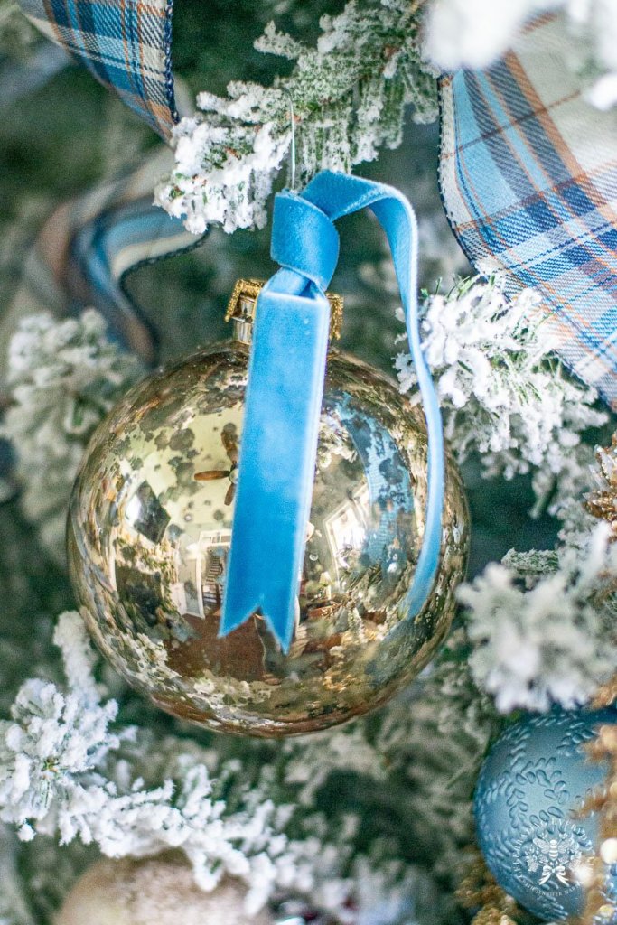 Cozy Blue Velvet Ribbon on Flocked Christmas Branch Cozy Blue Velvet Ribbon on Flocked Christmas Branch — Blue Christmas Decor