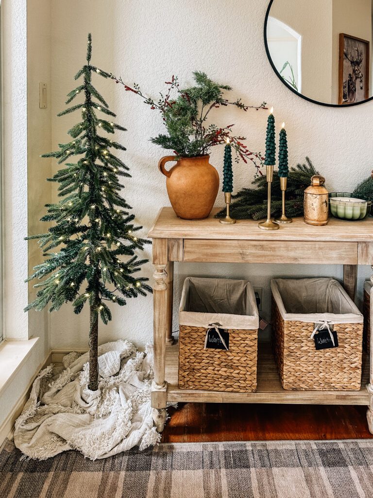 Boho Entryway Table with Lit Christmas Tree and Wicker Baskets Boho Entryway Table with Lit Christmas Tree and Wicker Baskets — Christmas Entryway Decor