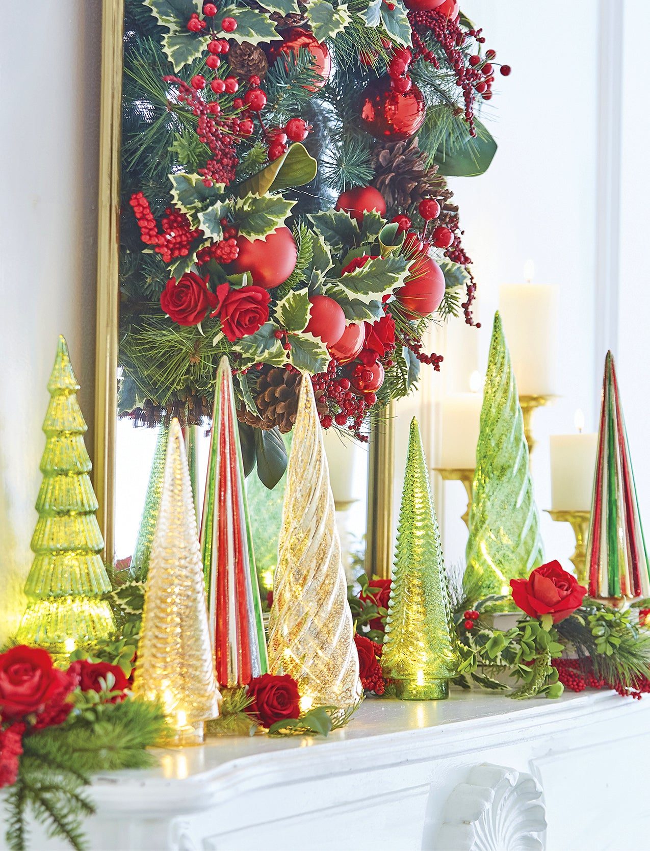 Mantelpiece with Illuminated Glass Trees and Greenery Wreath Mantelpiece with Illuminated Glass Trees and Greenery Wreath — Red and Green Christmas Decor