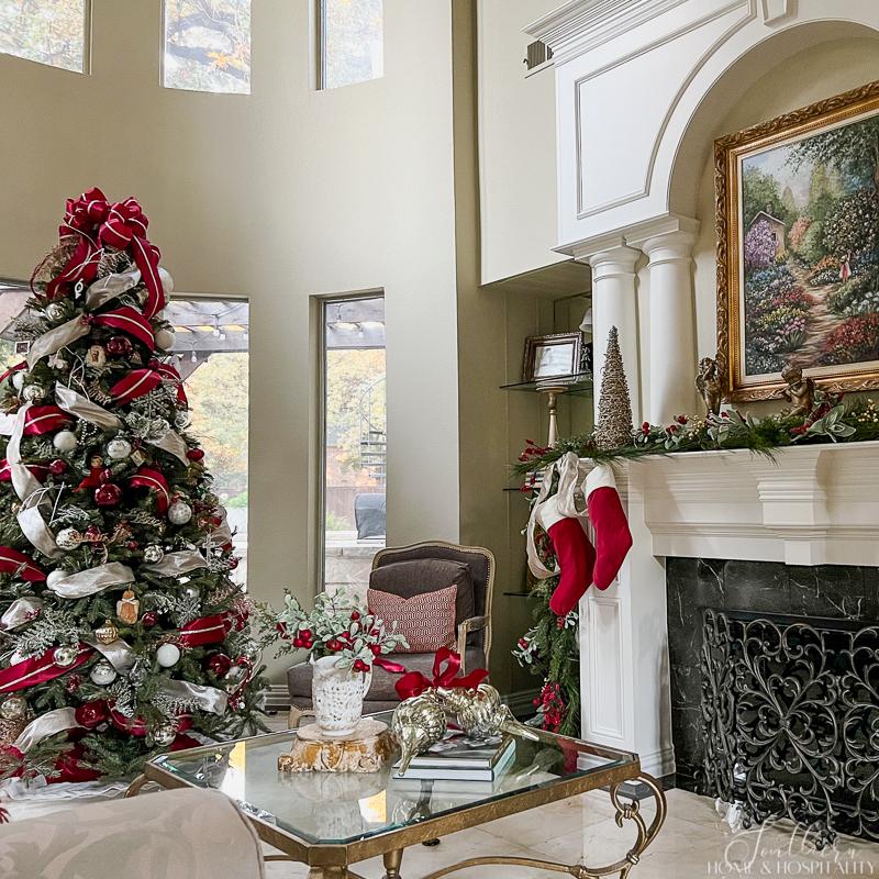 Red White Green Gold Spacious Traditional Living Room with Christmas Tree and Stocking-Adorned Fireplace — Traditional Christ