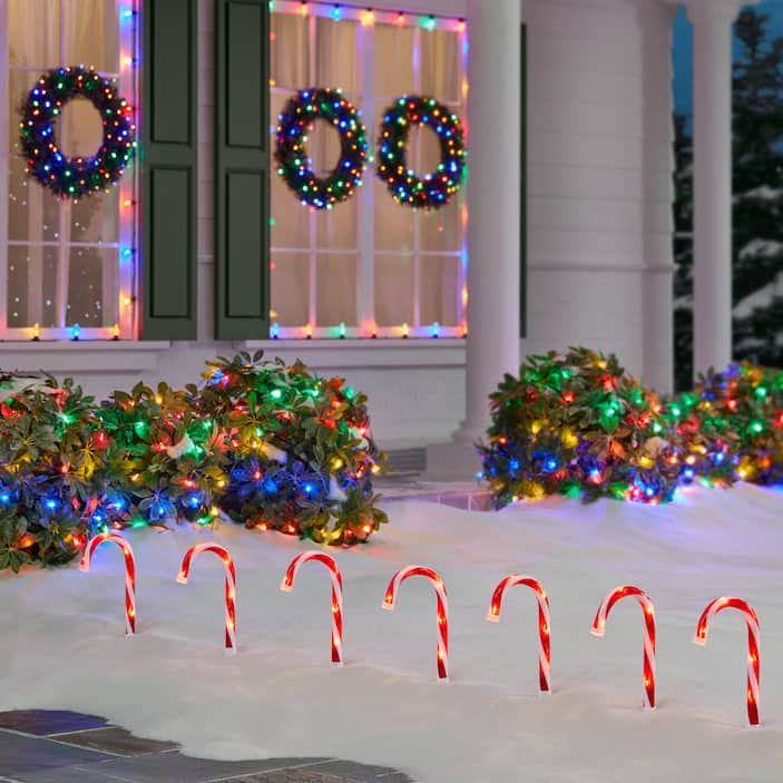 Vibrant Outdoor Window Display with Lit Wreaths and Colorful Lights Vibrant Outdoor Window Display with Lit Wreaths and Colorful Lights — Christmas Window Decor Outdoor