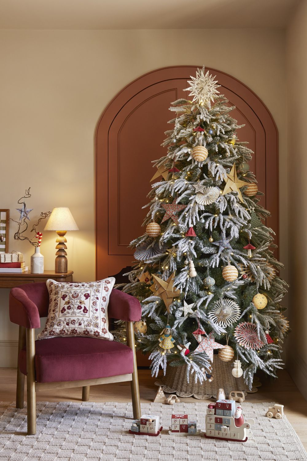 Modern Boho Living Room with Flocked Tree and Natural Ornaments Modern Boho Living Room with Flocked Tree and Natural Ornaments — christmas decor trends 2026