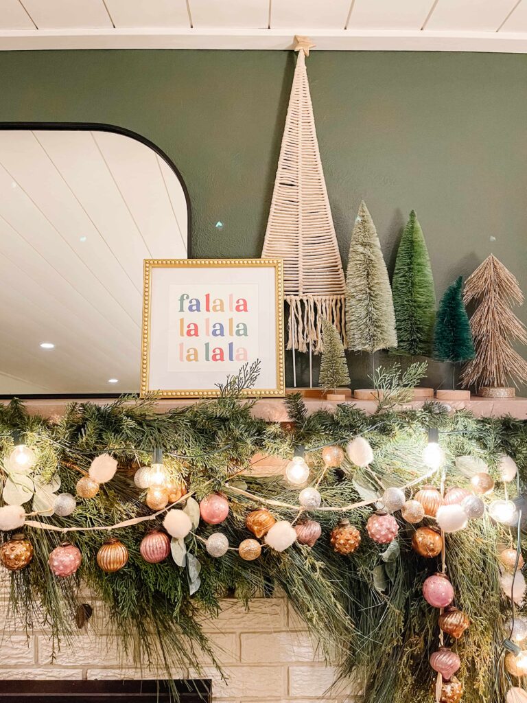 Whimsical Mantel with Abundant Garland, Pink Ornaments, and String Lights Whimsical Mantel with Abundant Garland, Pink Ornaments, and String Lights — Christmas Fireplace Decor