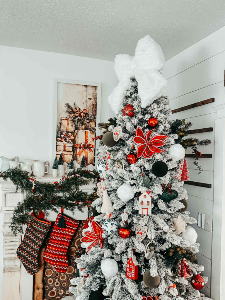 Farmhouse Flocked Tree with a Large White Bow and Red Accents — Elegant Christmas Tree