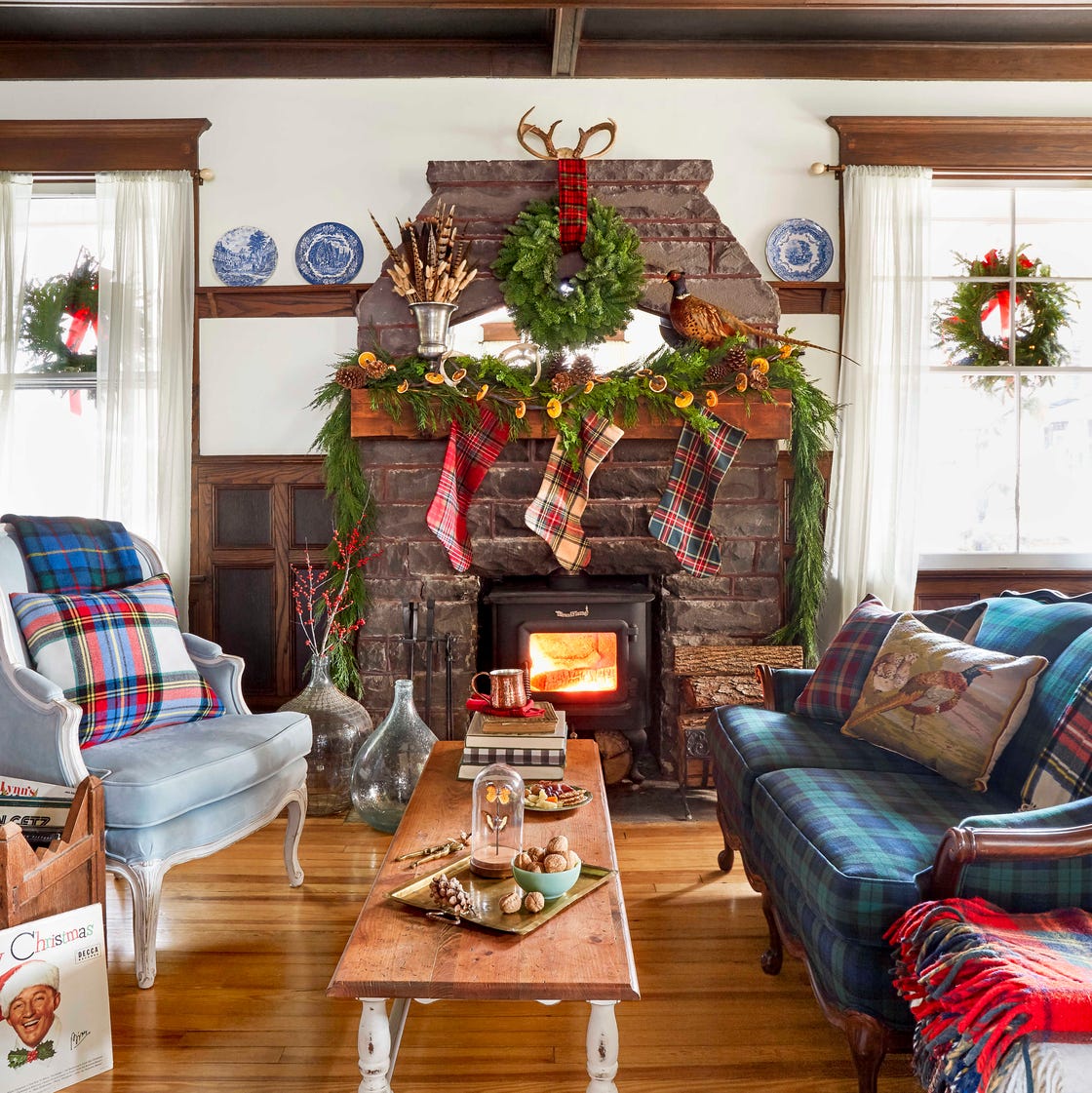 Rustic Farmhouse Living Room with Stone Fireplace and Plaid Accents Rustic Farmhouse Living Room with Stone Fireplace and Plaid Accents — Christmas Living Room Decor