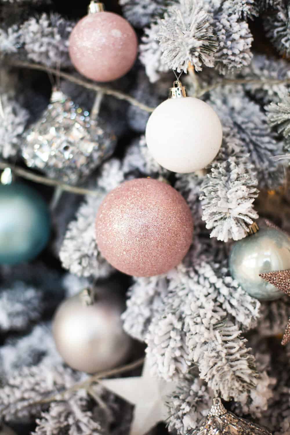 Textured Sparkle: Pink Glitter and Teal Ornaments on Flocked Branches Textured Sparkle: Pink Glitter and Teal Ornaments on Flocked Branches — Flocked Christmas Tree Decor
