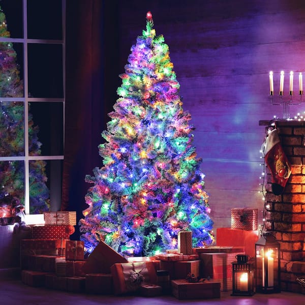 Tree Centered Fireplace To The Side Glam Living Room with Flocked Tree, Multicolor Lights, and Fireplace Tree Centered Fireplace To The Side Glam Living Room with Flocked Tree, Multicolor Lights, and Fireplace — Christmas Tree wit