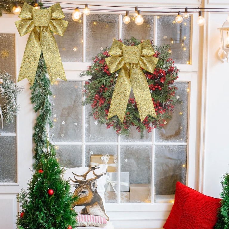 Festive Doorway with a Large Wreath and Glittery Gold Bows — Christmas Party Decor