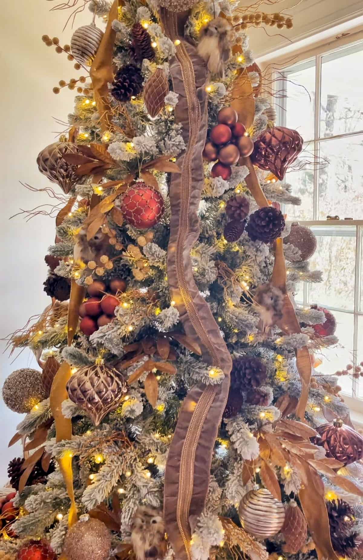 Rustic Flocked Tree with Burgundy, Gold, and Natural Elements — Christmas Tree Color Schemes