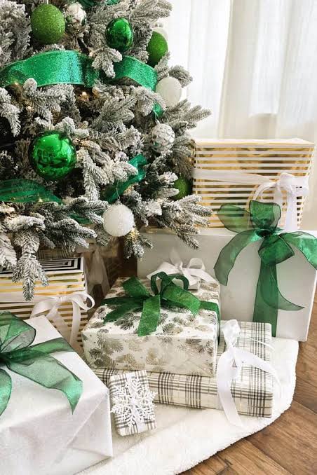 Vibrant Green Ribbons and Ornaments Under a Flocked Tree — Christmas Gift Wrapping