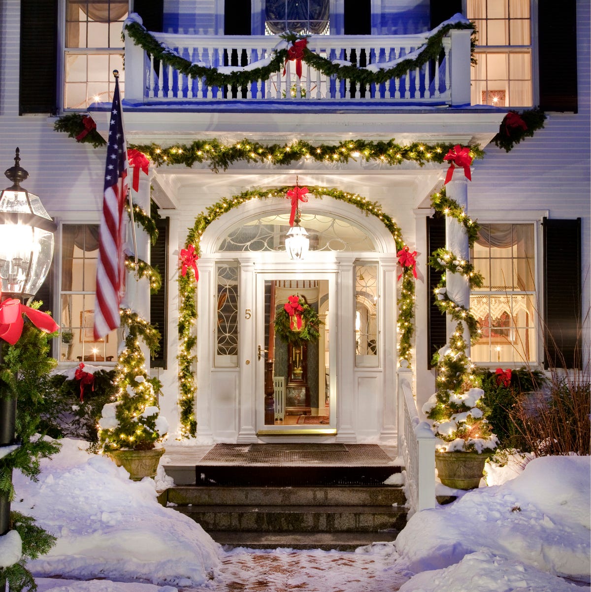 Grand Snow-Covered Entrance with Abundant Christmas Lights Grand Snow-Covered Entrance with Abundant Christmas Lights — Christmas Porch Decor