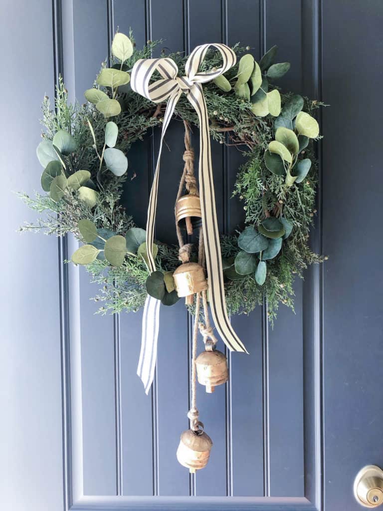 Cedar and Eucalyptus Wreath with Brass Bells on a Dark Door — DIY Christmas Wreath
