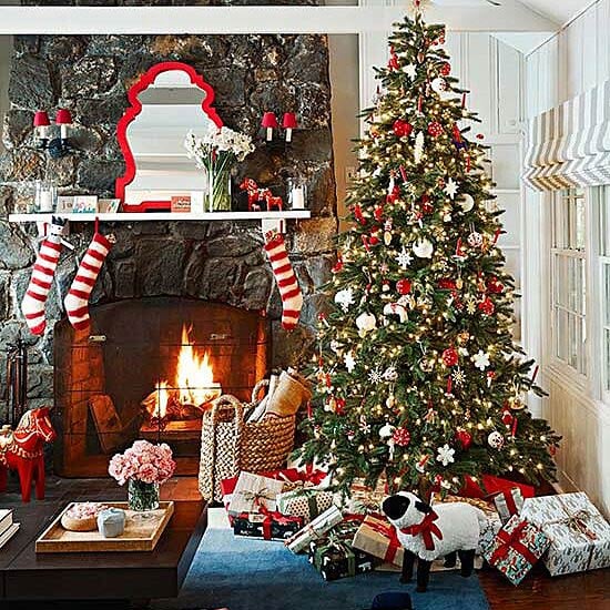 Medium Shot Traditional Living Room with Stone Fireplace, Striped Stockings, and Christmas Tree — Traditional Christmas Decor