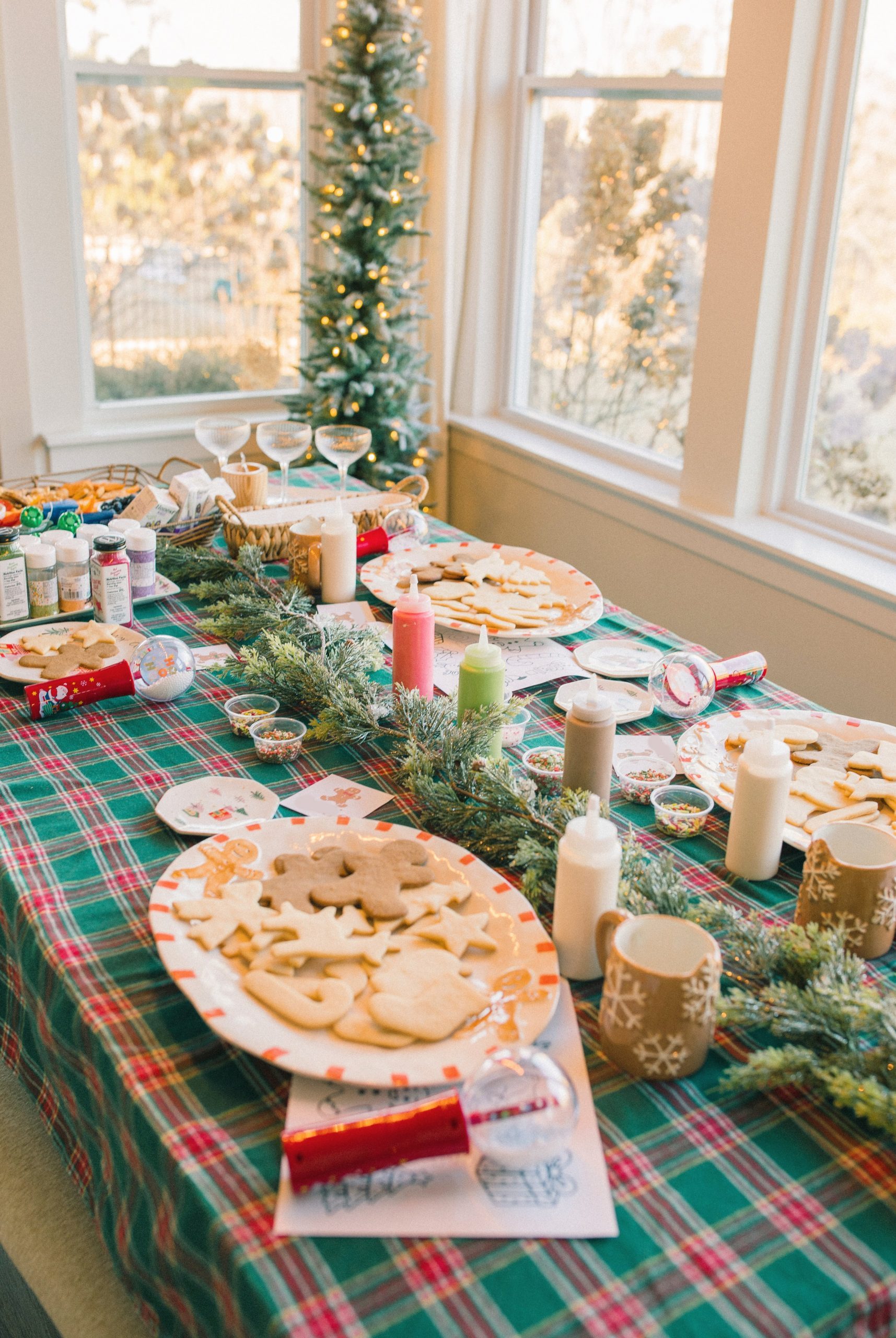 Christmas Cookie Decorating Station with Plaid Tablecloth and Icing Bottles — Christmas Party Decor