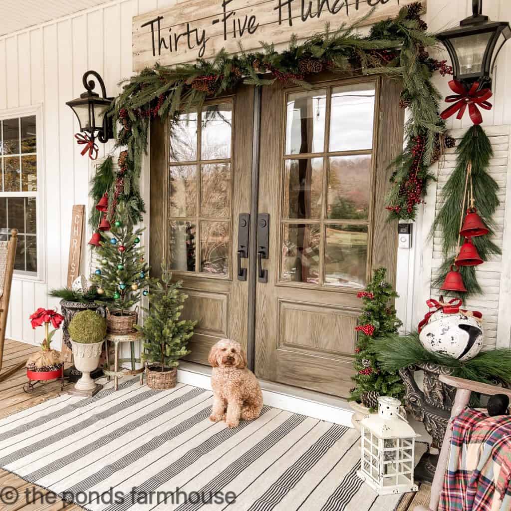 Grand Entrance with Double Doors, Garland, and Small Christmas Trees — Farmhouse Christmas Porch