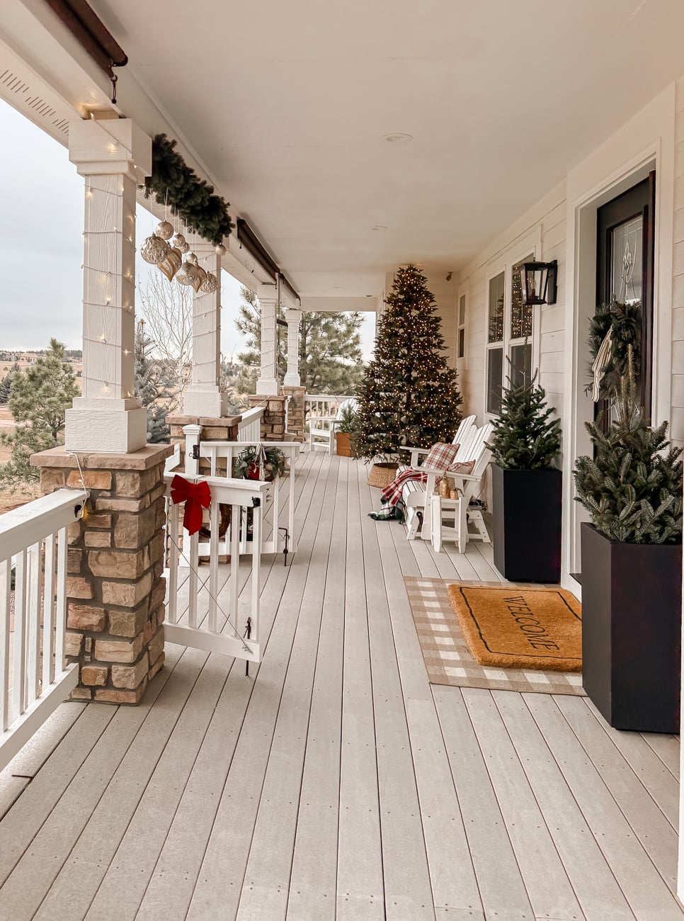 Spacious Farmhouse Porch with a Large Christmas Tree and Seating — Farmhouse Christmas Decor
