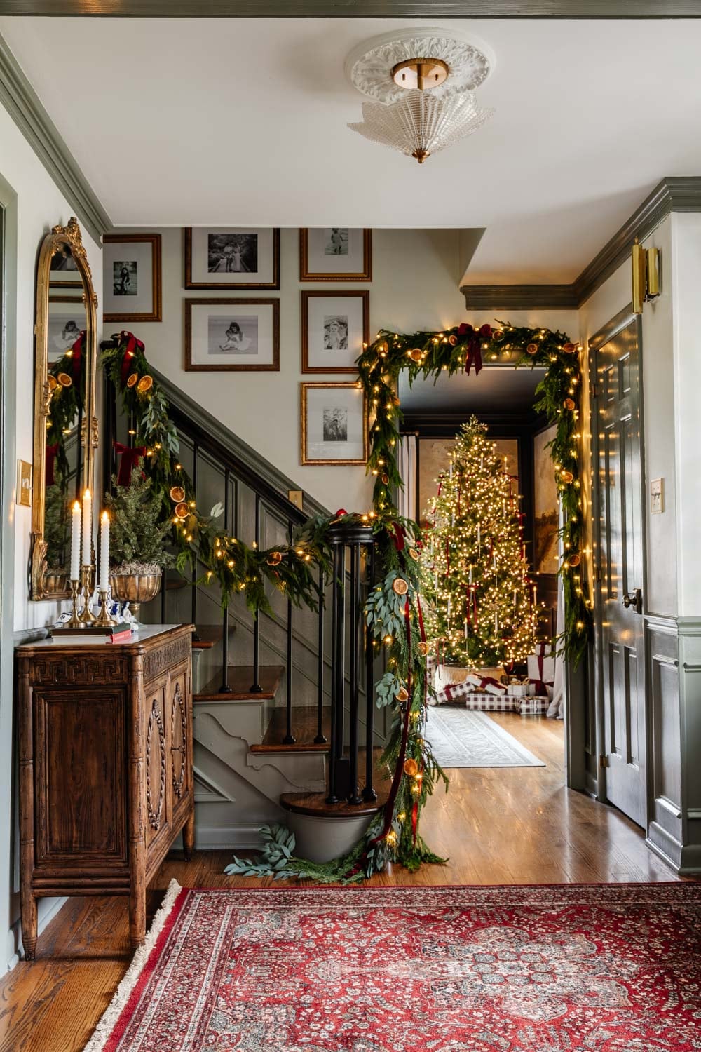 Traditional Entryway with Evergreen Garland, Dried Oranges, and Christmas Tree — Traditional Christmas Decor