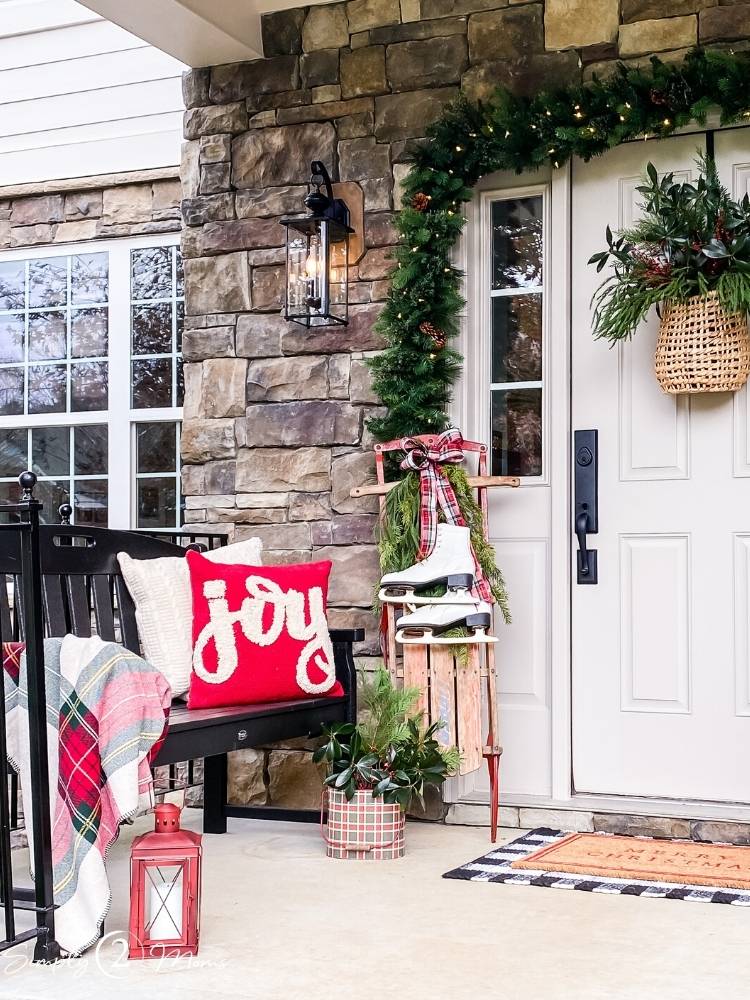 Rustic Seating Area with Plaid Blanket and Vintage Ice Skates — Farmhouse Christmas Porch