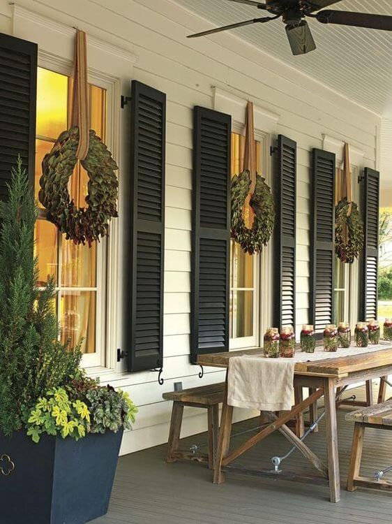 Farmhouse Porch with a Row of Simple Christmas Wreaths Farmhouse Porch with a Row of Simple Christmas Wreaths — Christmas Window Decor Outdoor