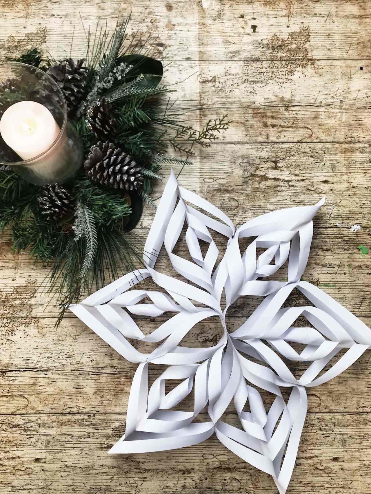 Folded 3D Paper Snowflake on Rustic Wooden Surface — Paper Snowflakes
