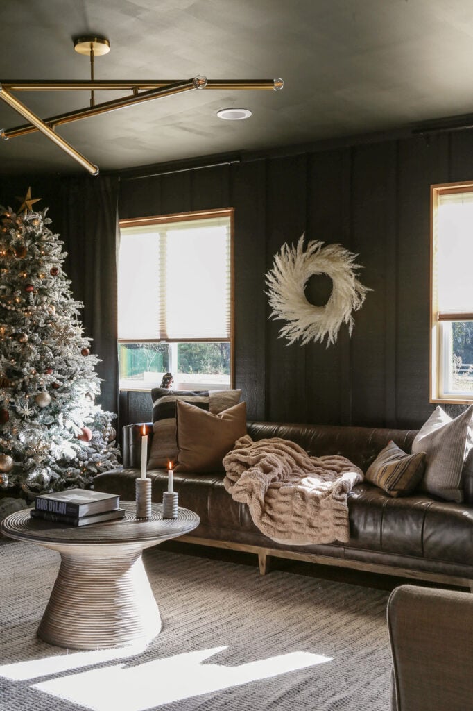 Modern Living Room with Dark Wood Paneling and Pampas Grass Wreath — Modern Christmas Decor