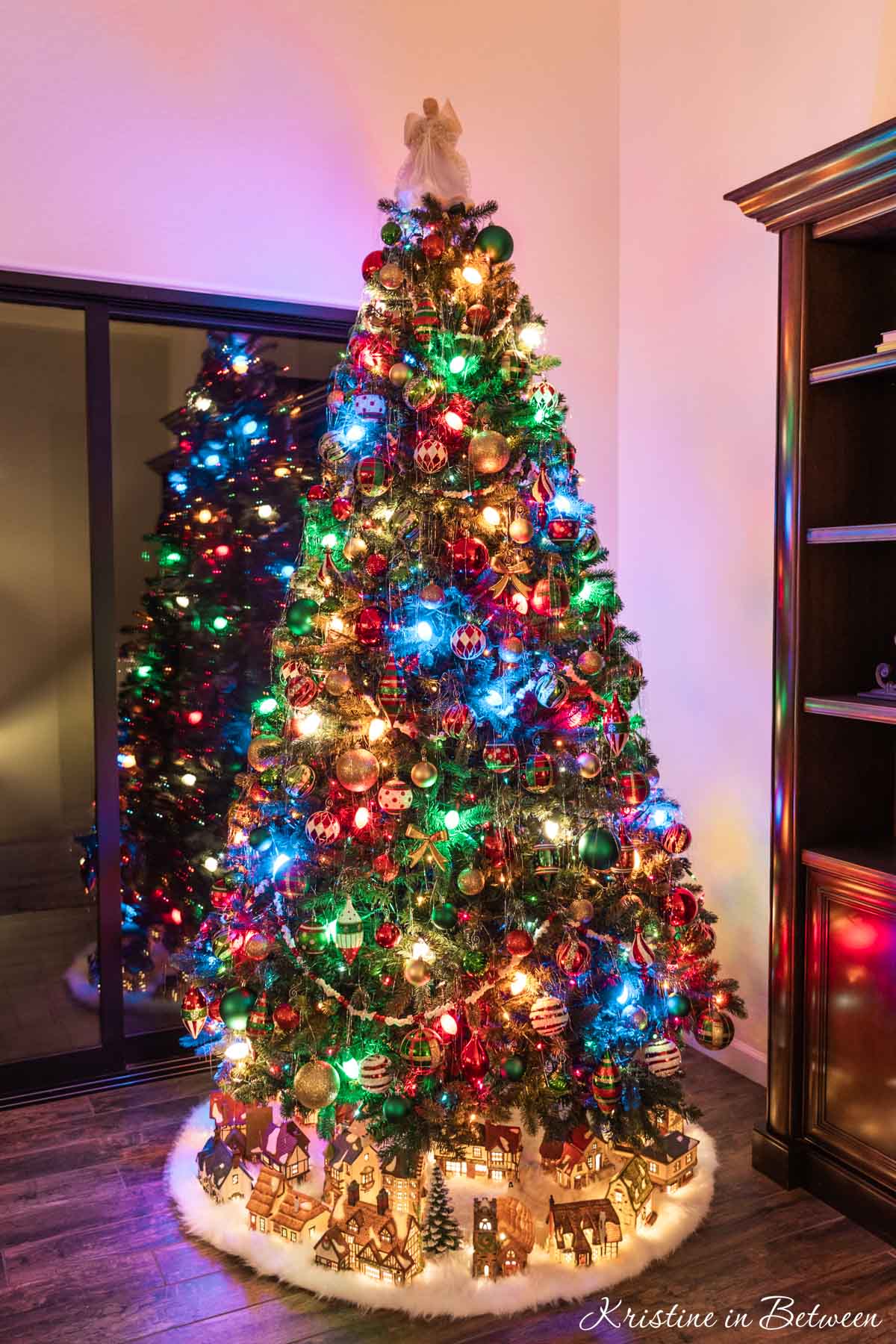 Traditional Tree with Village Scene and Multicolor Lights Traditional Tree with Village Scene and Multicolor Lights — Christmas Tree with Colored Lights
