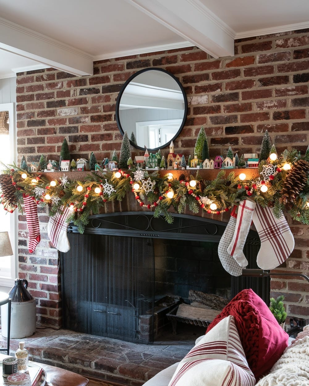 Traditional Fireplace with Miniature Village and Red/White Striped Stockings Traditional Fireplace with Miniature Village and Red/White Striped Stockings — Christmas Fireplace Decor